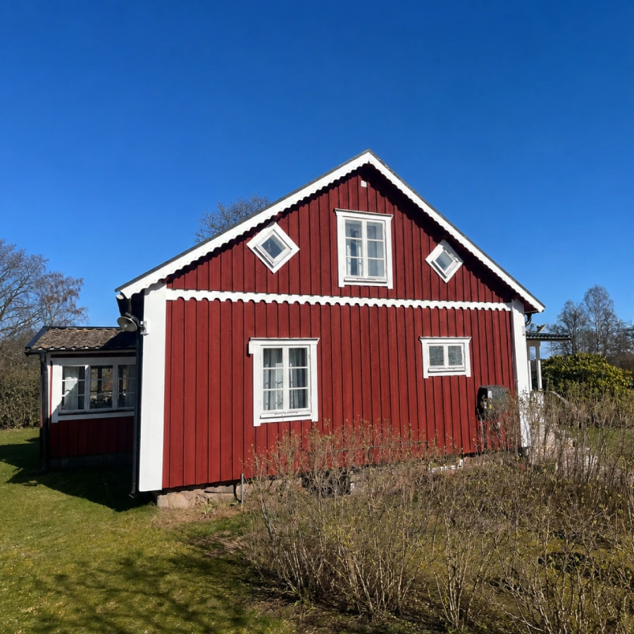 Ny fasad på rött hus efter byte av fasadgavel.